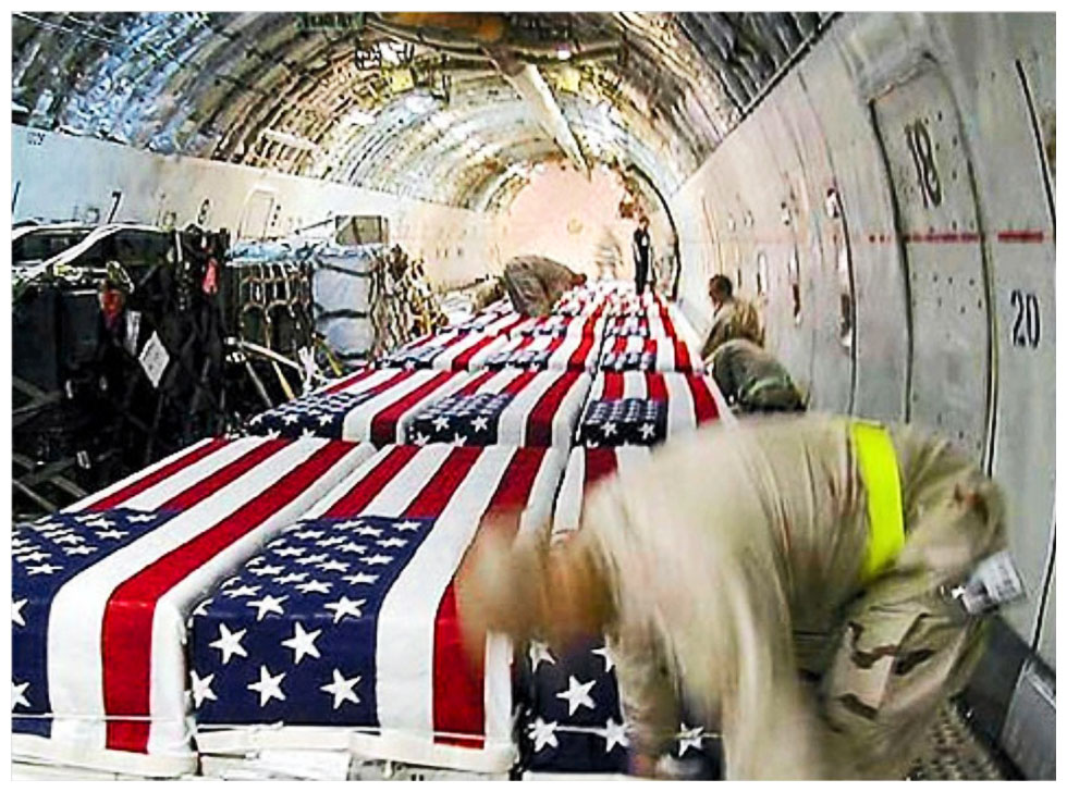 https://whywarsucks.files.wordpress.com/2011/10/coffins-of-u-s-soldiers-inside-a-cargo-plane-at-kuwait-international-airport-in-april-2004.jpg